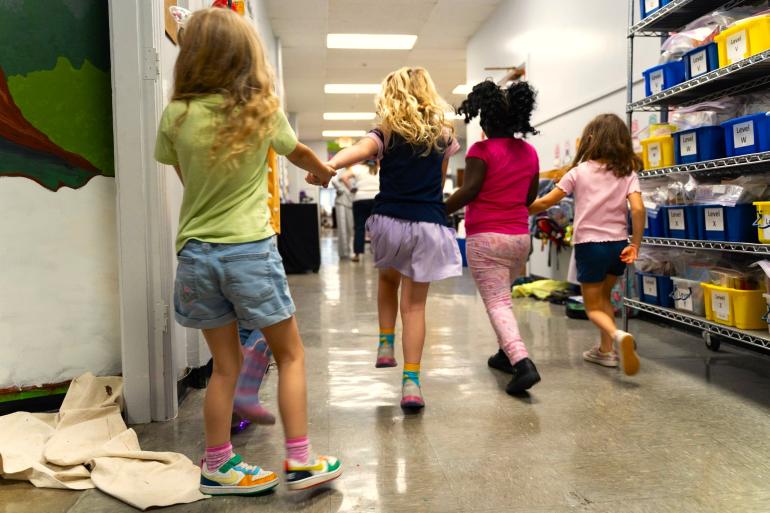 ABC Arts Learning at Home Intro Photo A group of students skips down the hallway together