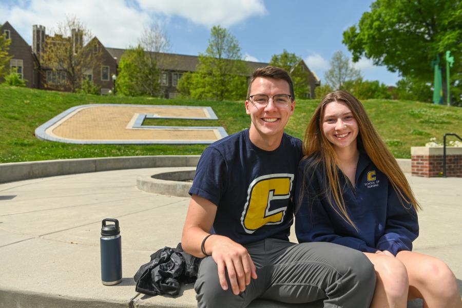 UTC students during a Power C Tour sitting outside on Chamberlain Field