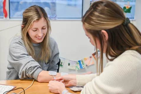 UTC Occupational Therapy student in a workshop placing a sensor